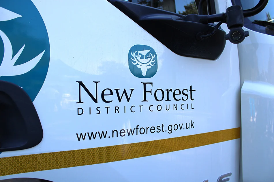 Vehicle displaying the New Forest District Council logo and website URL (www.newforest.gov.uk) on its side.